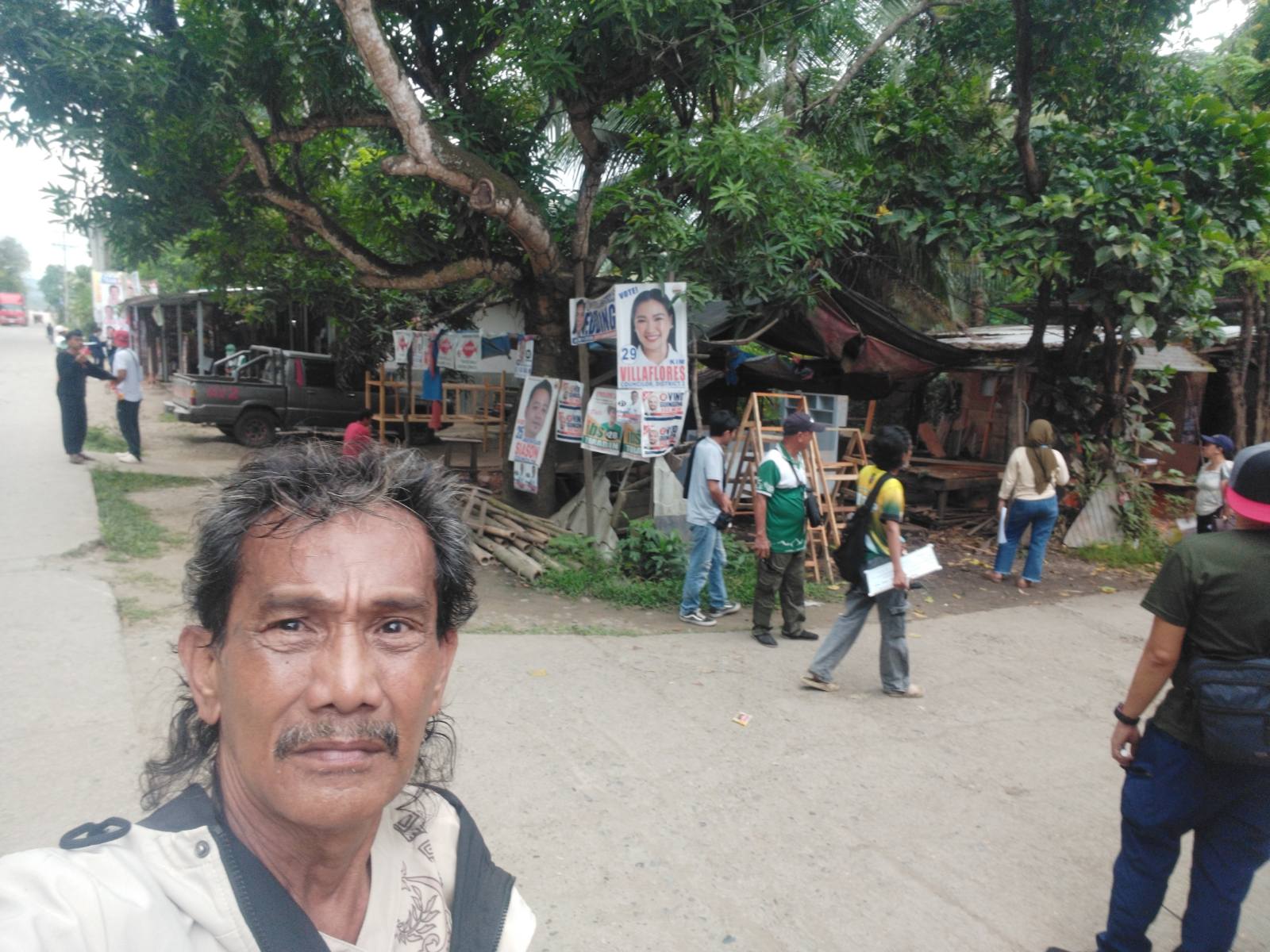 Socio-economic survey team documenting roadside community conditions
